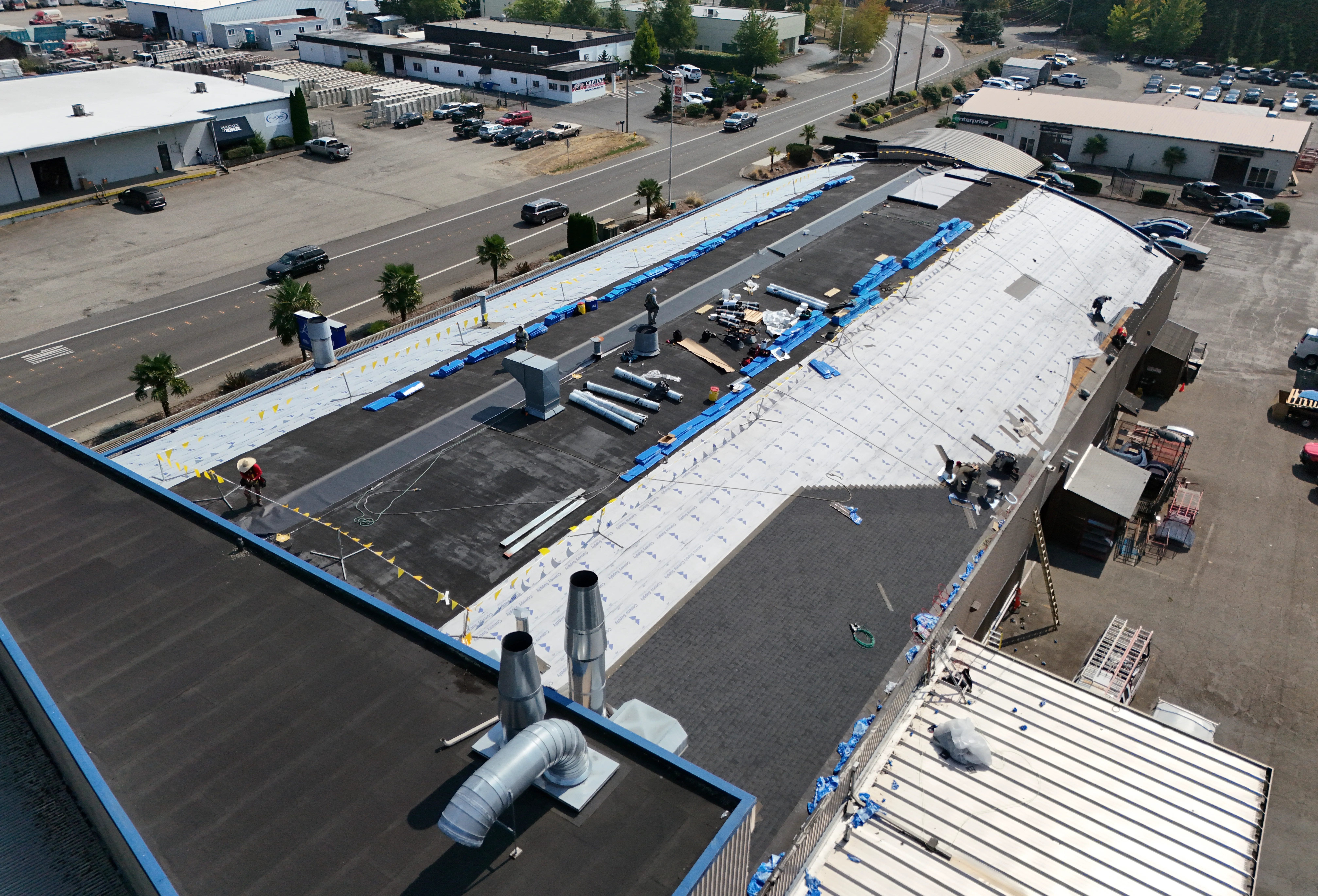 Commercial Roof Replacement Options Roof under construction with materials visible.