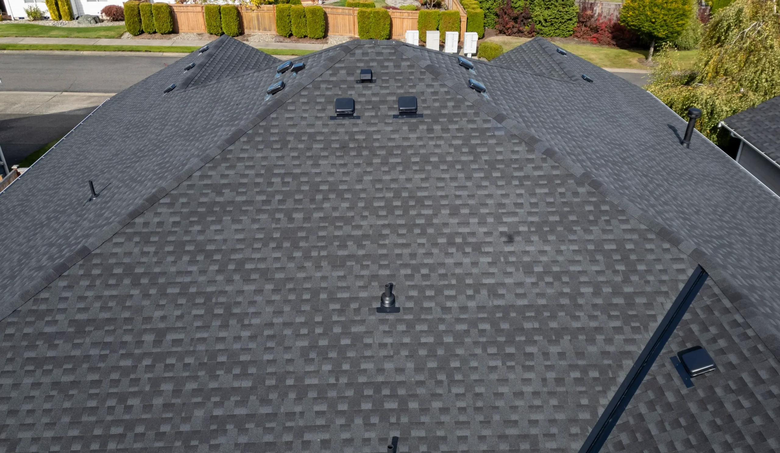 Olympia Roof Repair Tips How to Spot Hidden Leaks Early (1) Aerial view of a gray shingle roof.
