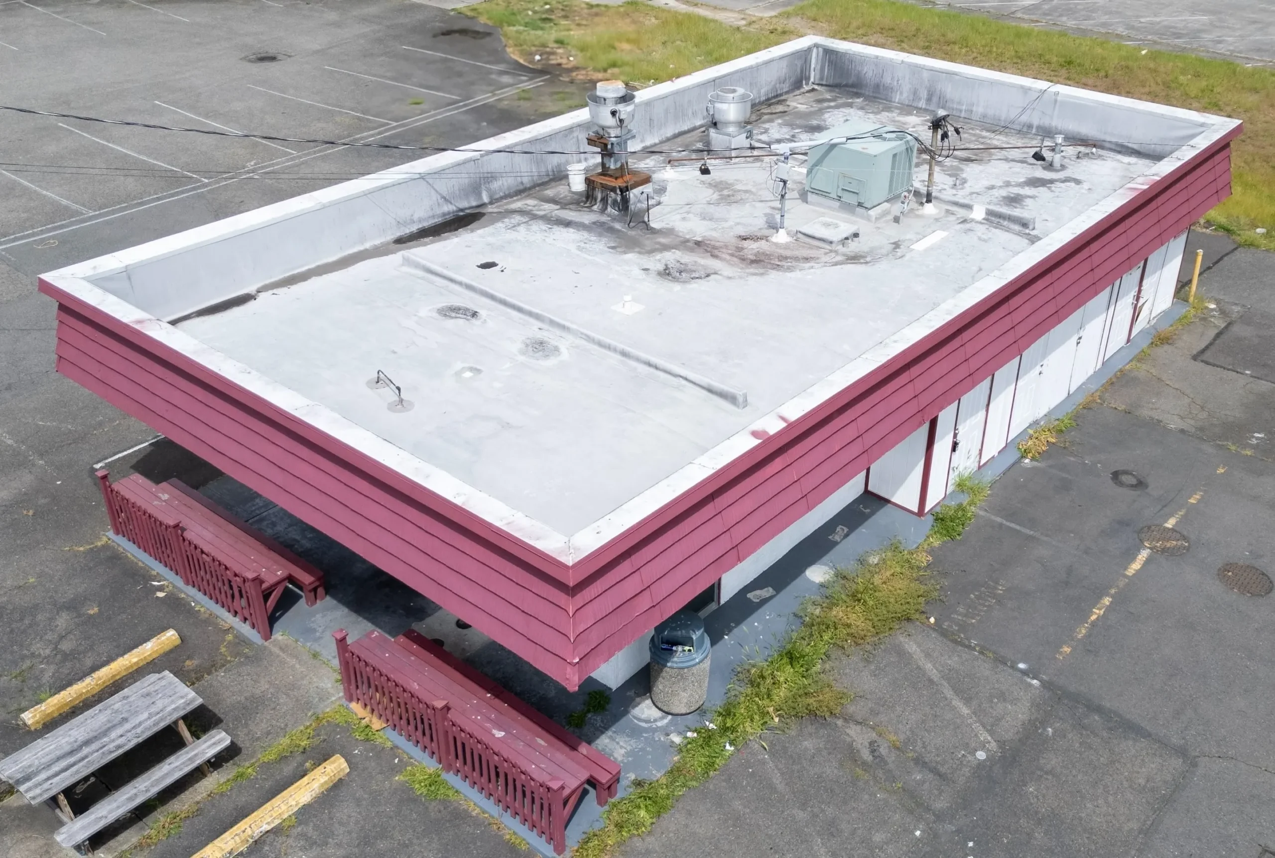 Winter Challenges for Seattle Commercial Roofs & How Roofers Can Help Flat roof with equipment and debris