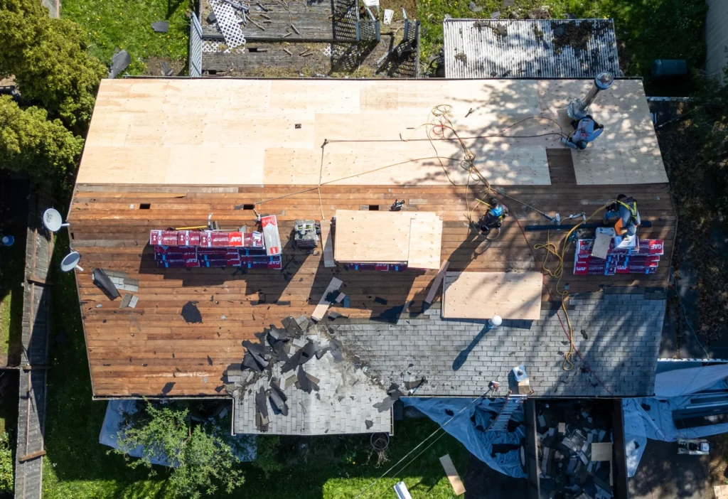 Roof replacement in progress, materials visible.